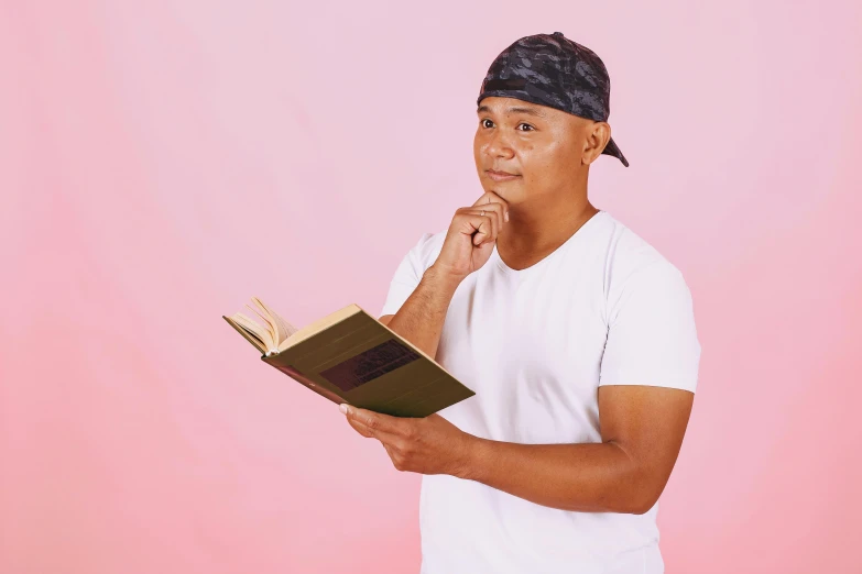 the young man is holding a book in his hands