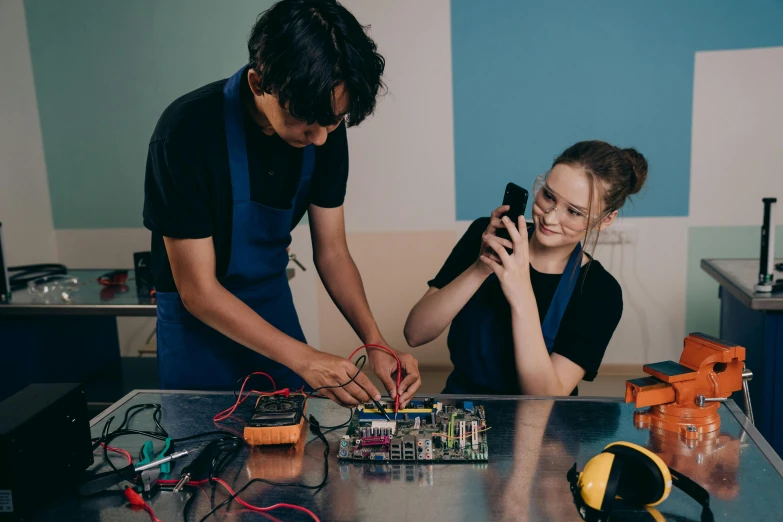 a man and a woman working on electronics, a portrait, pexels contest winner, school class, 15081959 21121991 01012000 4k, chillwave, promotional image