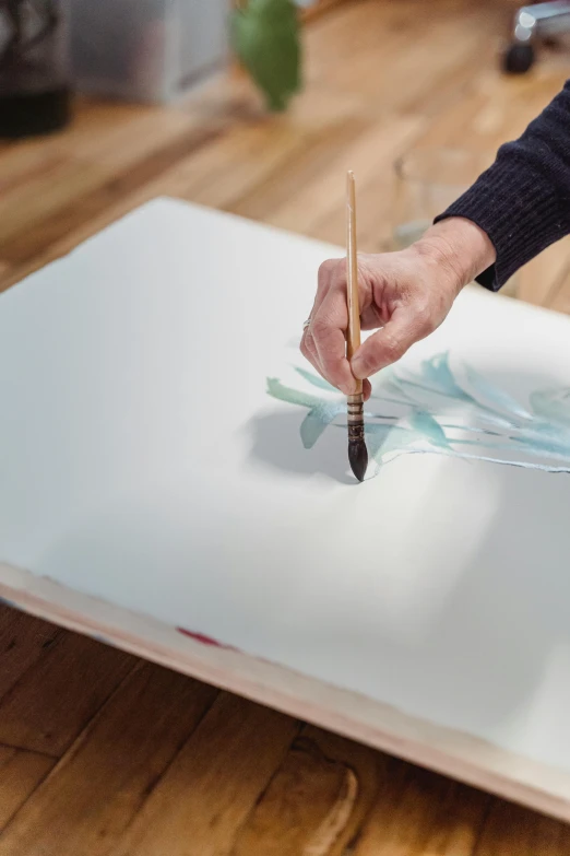 a person painting on a canvas on a wooden floor, botanic watercolors, intricate brush stroke detail, glass paint, on white paper