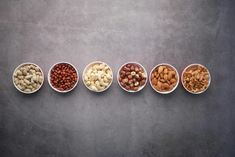 a row of bowls filled with different kinds of nuts, inspired by david rubín, trending on pexels, hyperrealism, grid of styles, halo halo halo halo 8k, grainy quality, white