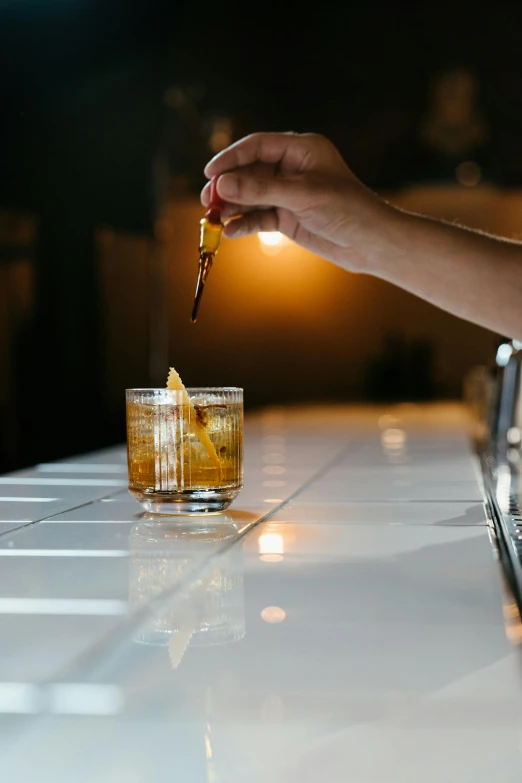 a person pouring a drink at a bar, by Austin English, old fashioned, light on top, long trunk holding a wand, crisp lines