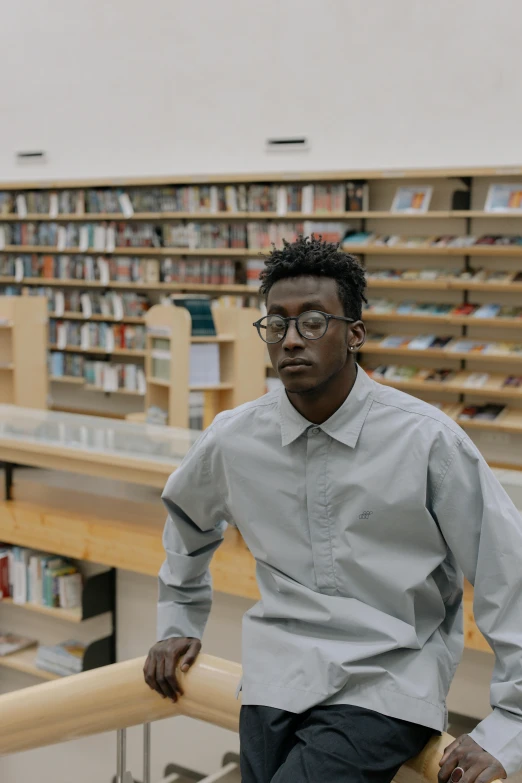 a man with glasses is sitting in a liry