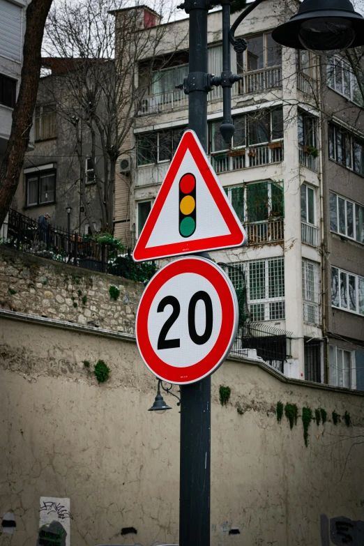 a red and white traffic sign on a pole