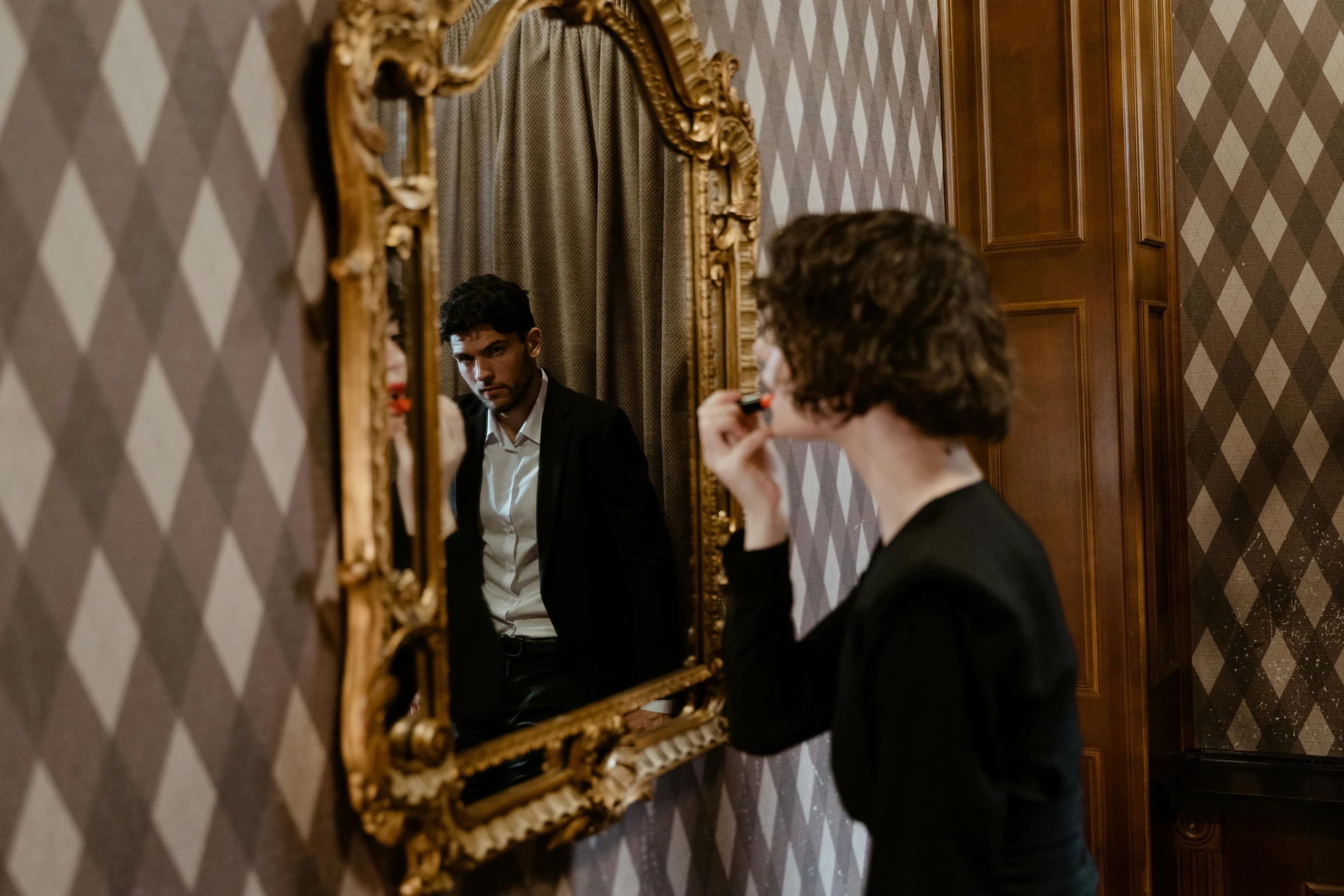 a woman brushing her teeth in front of a mirror, by Emma Andijewska, pexels contest winner, renaissance, young man, elegantly dressed, josh black, facing away from the camera