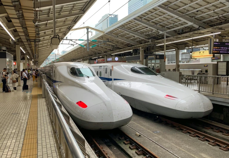 a couple of trains that are next to each other, pexels contest winner, sōsaku hanga, 💋 💄 👠 👗, white, commercially ready, japanese