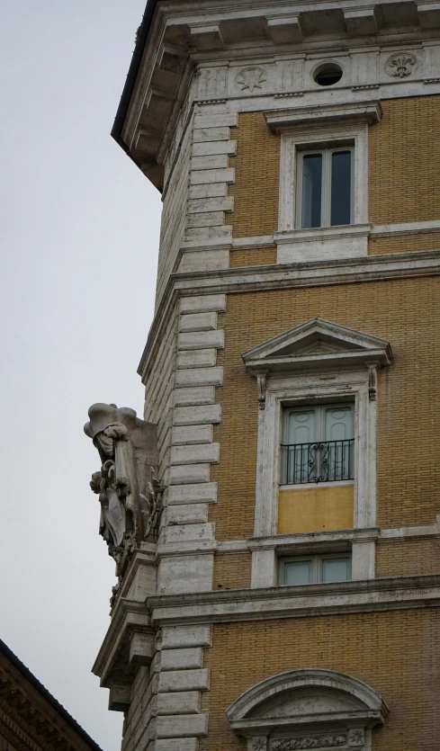 a clock that is on the side of a building, a statue, by Cagnaccio di San Pietro, second eagle head, curls on top of his head, seen from a distance, yellow windows and details