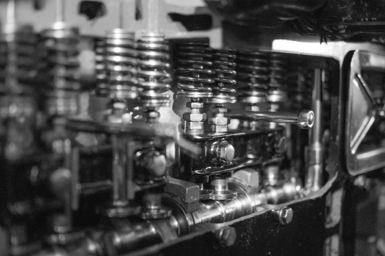 a black and white photo of a machine, a macro photograph, by David Simpson, flickr, valves, automobile, 1 6 mm film, golden engines