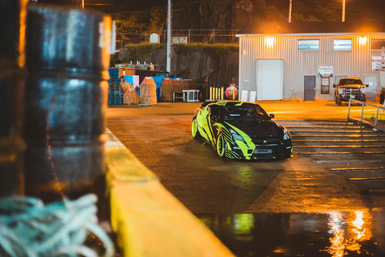 an automobile parked in a parking lot on a rainy night