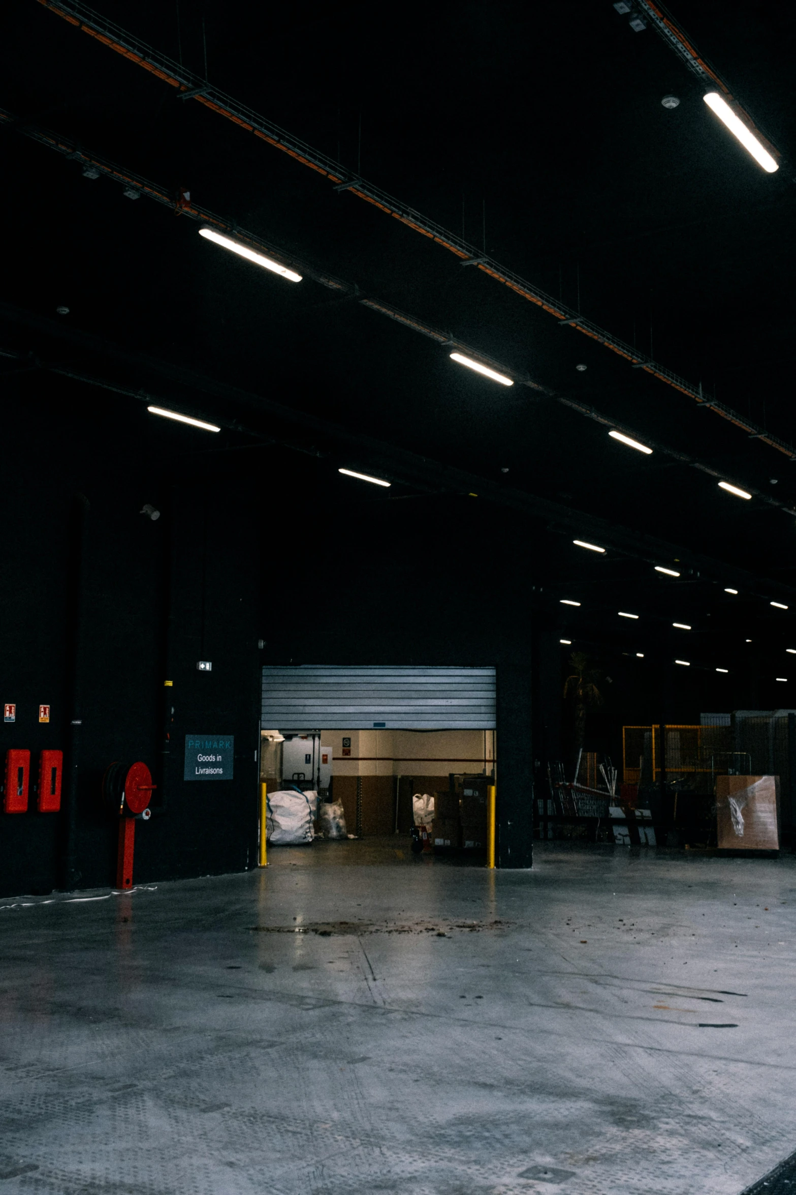 the inside of a warehouse with empty parking spaces