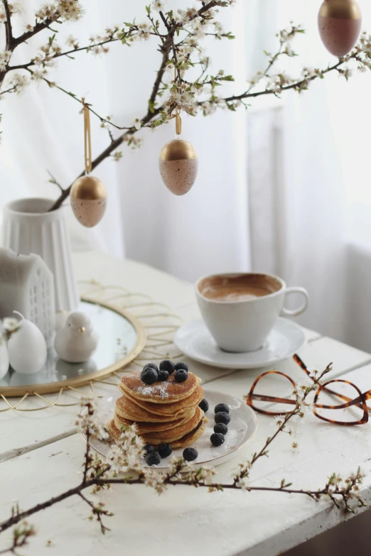 a table topped with a stack of pancakes next to a cup of coffee, pexels contest winner, renaissance, easter, overhanging branches, gif, white