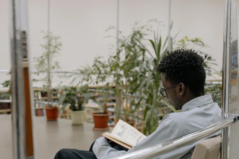 a man sitting in a chair reading a book