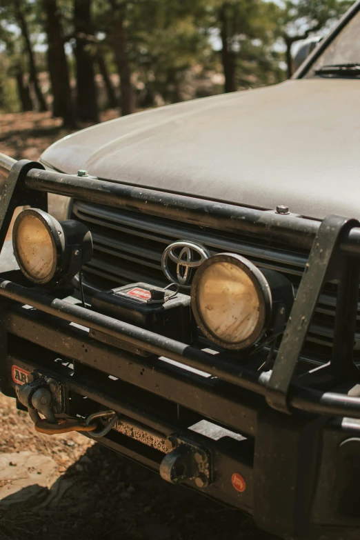 a truck parked on the side of a dirt road, custom headlights, upper body close up, outback, profile image