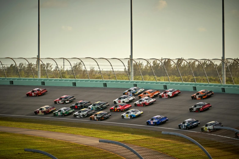 a car race is going in the middle of the ring