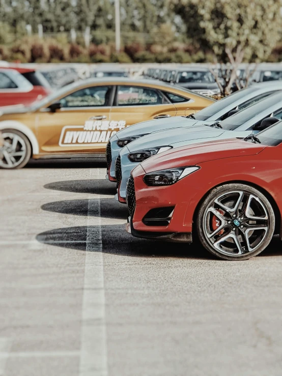 a row of cars sitting next to each other in parking spaces