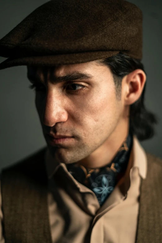 a close up of a person wearing a hat, a character portrait, inspired by Federico Zandomeneghi, unsplash, photorealism, handsome prince of persia, wearing 1 9 2 0 s cloth hair, vintage color photo, style of ade santora