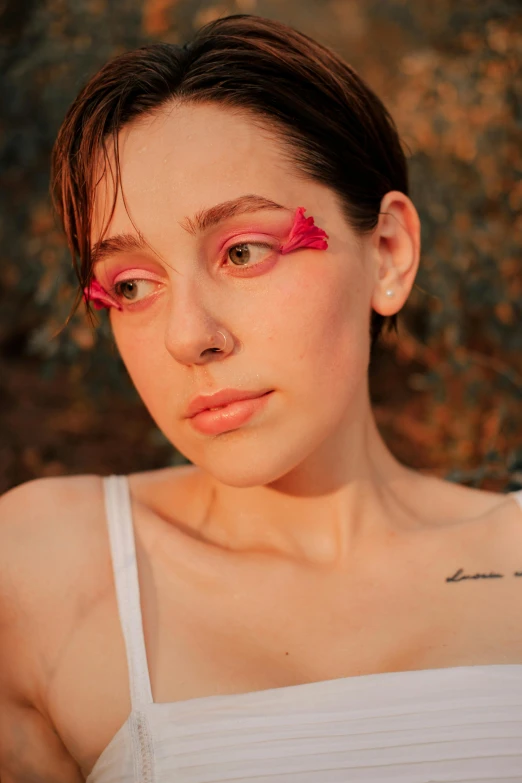 a woman with pink eyeliners on her face, an album cover, inspired by Elsa Bleda, trending on pexels, portrait androgynous girl, half-woman half-butterfly, sun down, non binary model