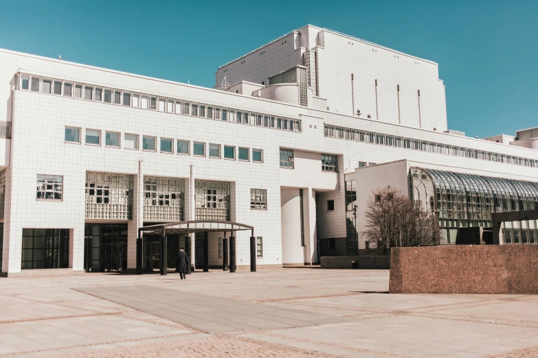 a large white building with a blue sky in the background, unsplash, bauhaus, war theatre, reykjavik junior college, coventry city centre, thumbnail