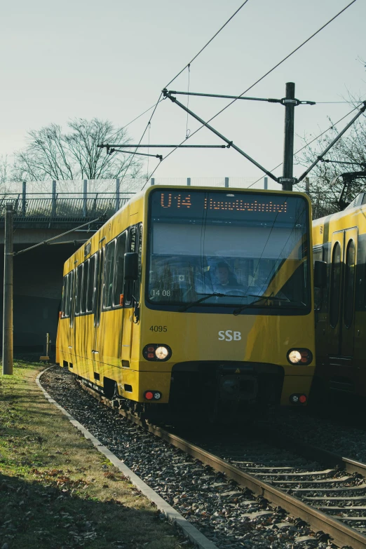 two yellow train cars are next to each other