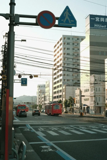 a street scene with focus on the red bus