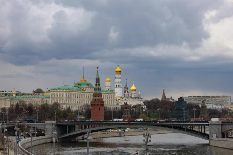 a bridge over a river with buildings in the background, an album cover, inspired by Vasily Surikov, pexels contest winner, socialist realism, gray clouds, kremlin, panoramic view, 000 — википедия