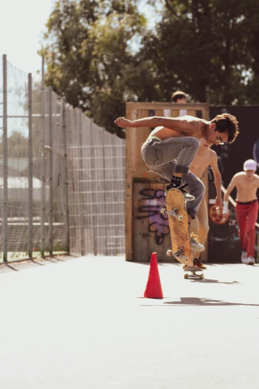 a man flying through the air while riding a skateboard, unsplash, photorealism, low quality footage, block party, in spain, cone