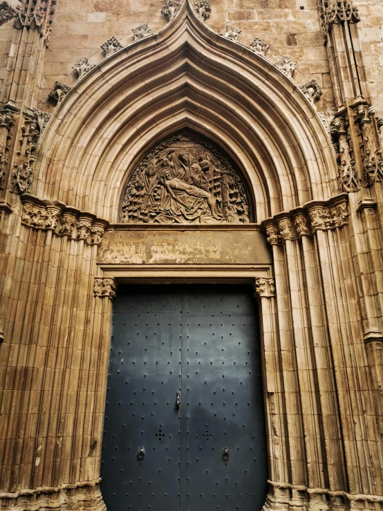 a large stone building with a black door, inspired by Modest Urgell, pexels contest winner, romanesque, extreme intricate metal details, cathedral!!!!!, preserved historical, bartolome ros