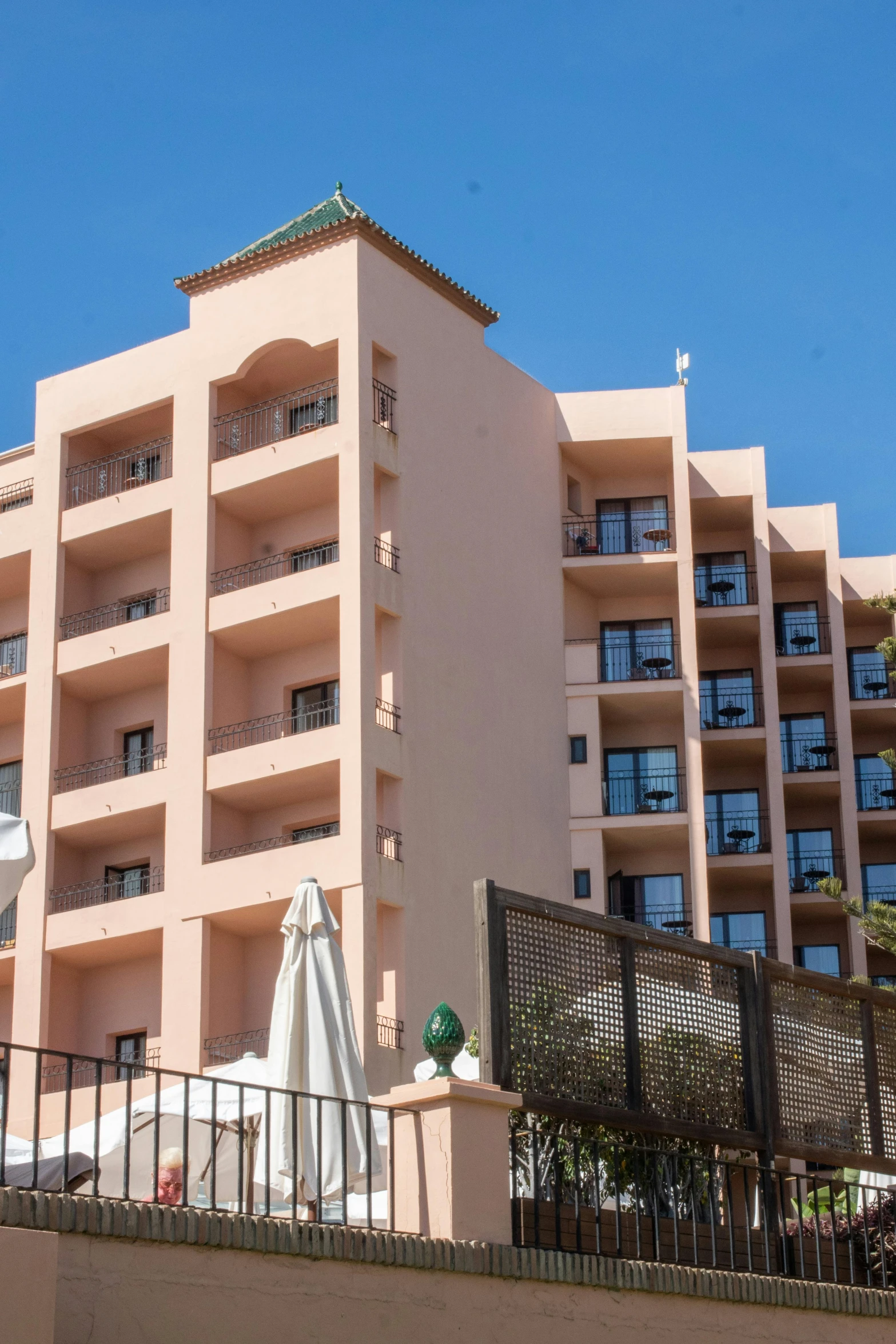 an apartment building is shown with two pools on the ground