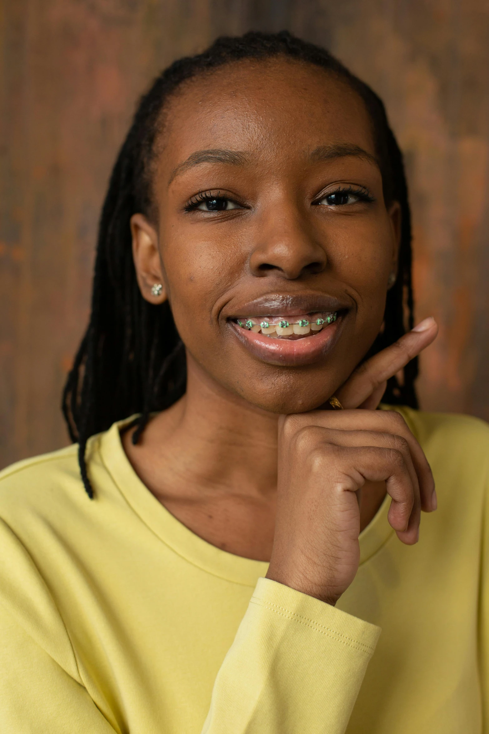 a woman in a yellow shirt posing for a picture, by Dorothy Bradford, underbite, black teenage girl, official product photo, contest winner 2021