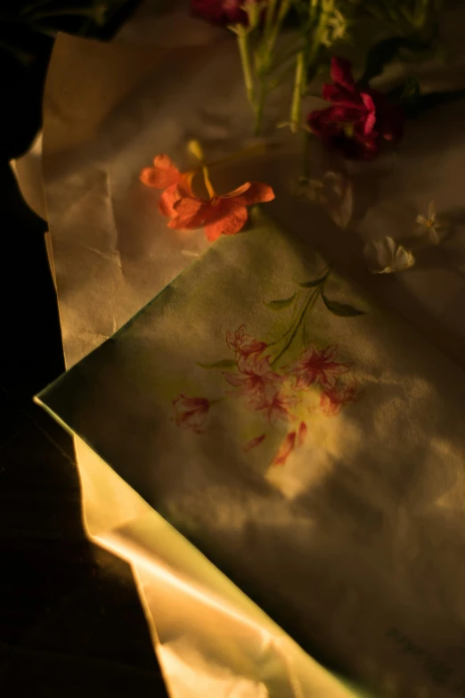 an envelope with red flowers on the inside