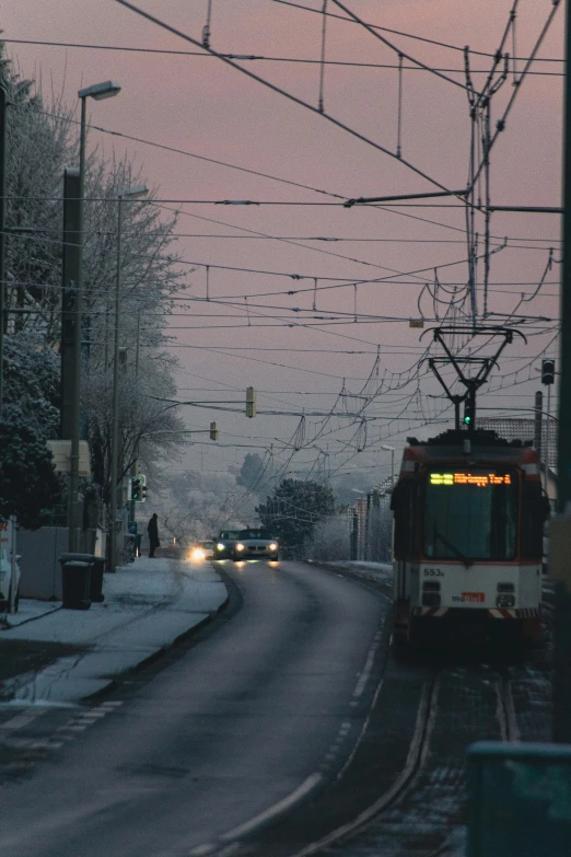 a train passes under electrical wires during the winter