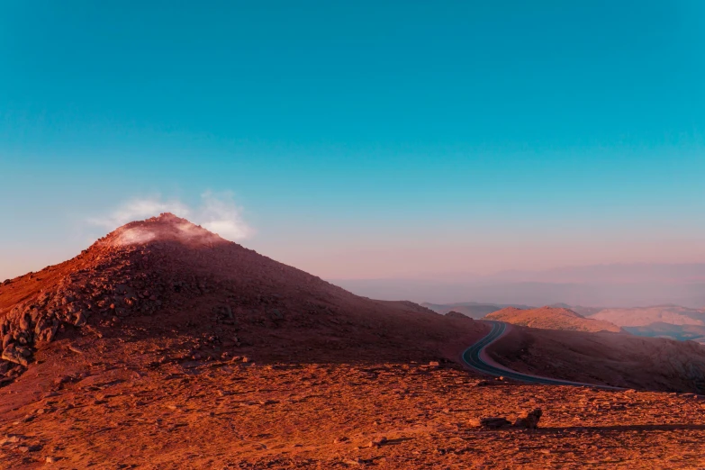 a mountain is shown with a long curved road