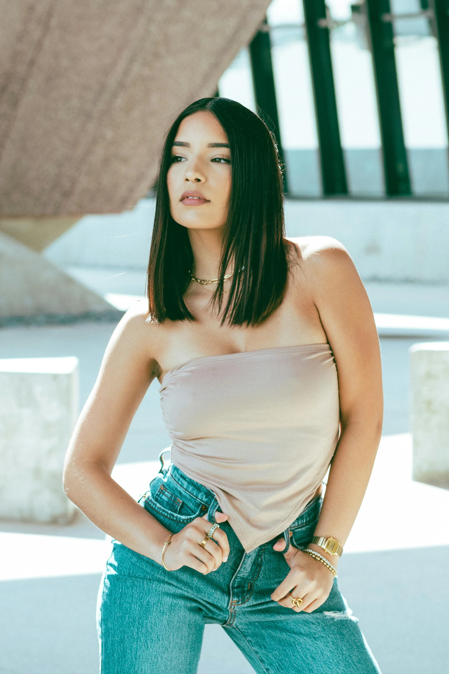 a woman in a tank top and jeans posing for a picture, by Robbie Trevino, mai anh tran, wearing a crop top, sun overhead, sophisticated young woman