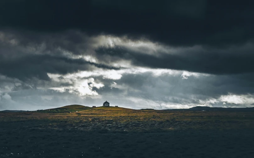 a hill with a building sitting on top of it