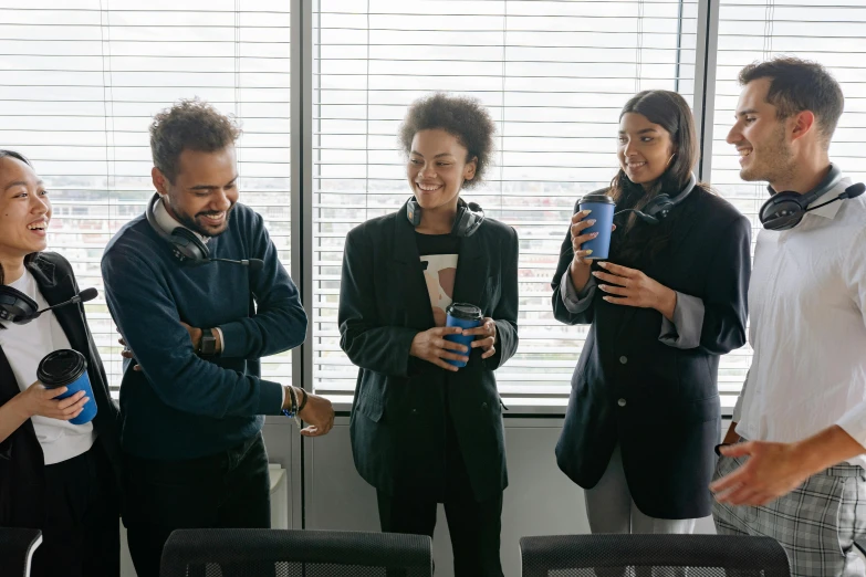 a group of people standing next to each other, drinking a coffee, in an office, profile image, nathalie emmanuel