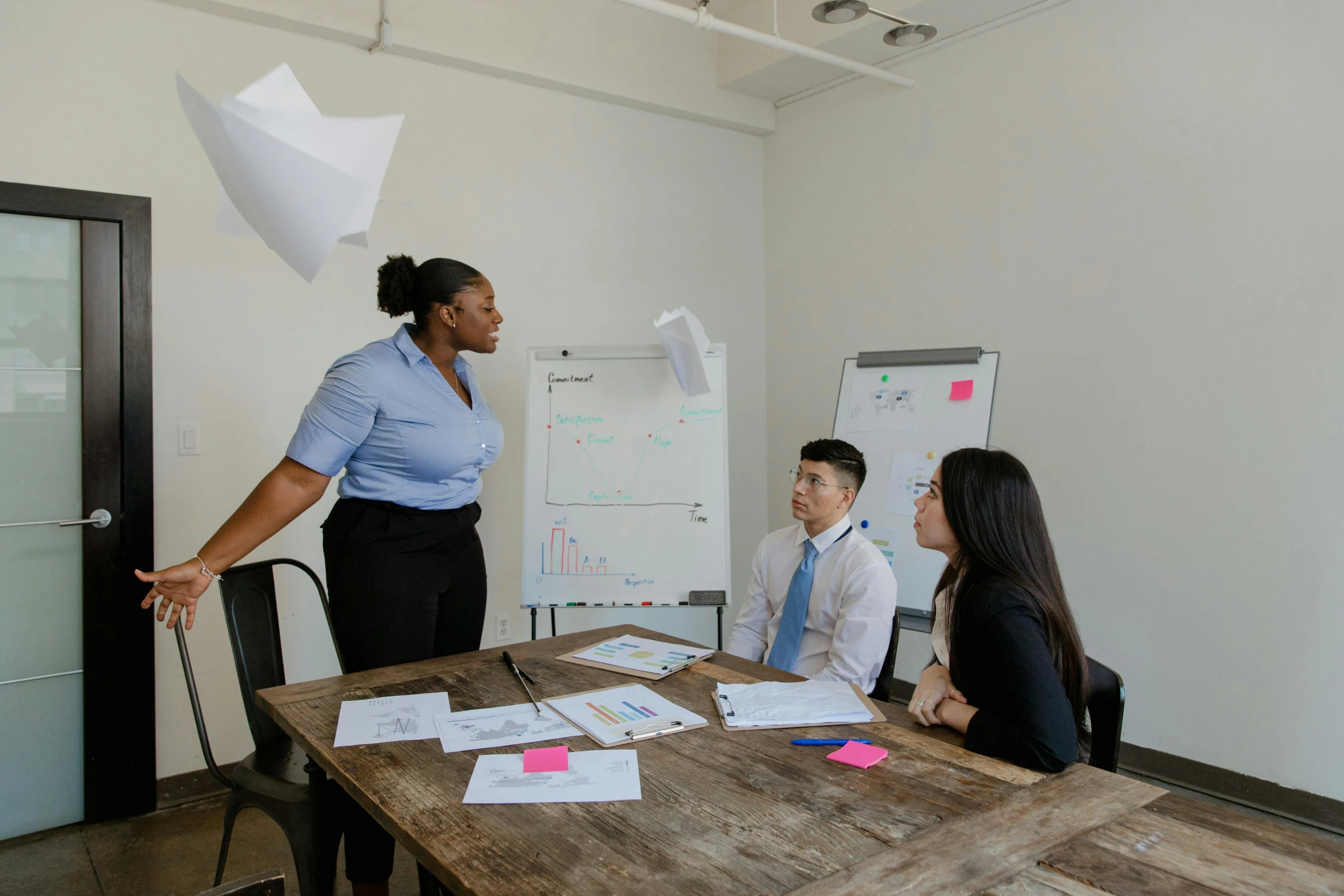 a group of people sitting around a wooden table, on a desk, profile image, whiteboards, thumbnail