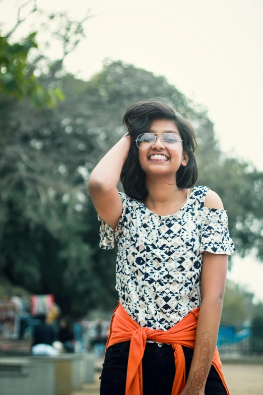 a woman that is standing in the dirt, a picture, unsplash, cute slightly nerdy smile, assamese aesthetic, wearing a designer top, backlit!!