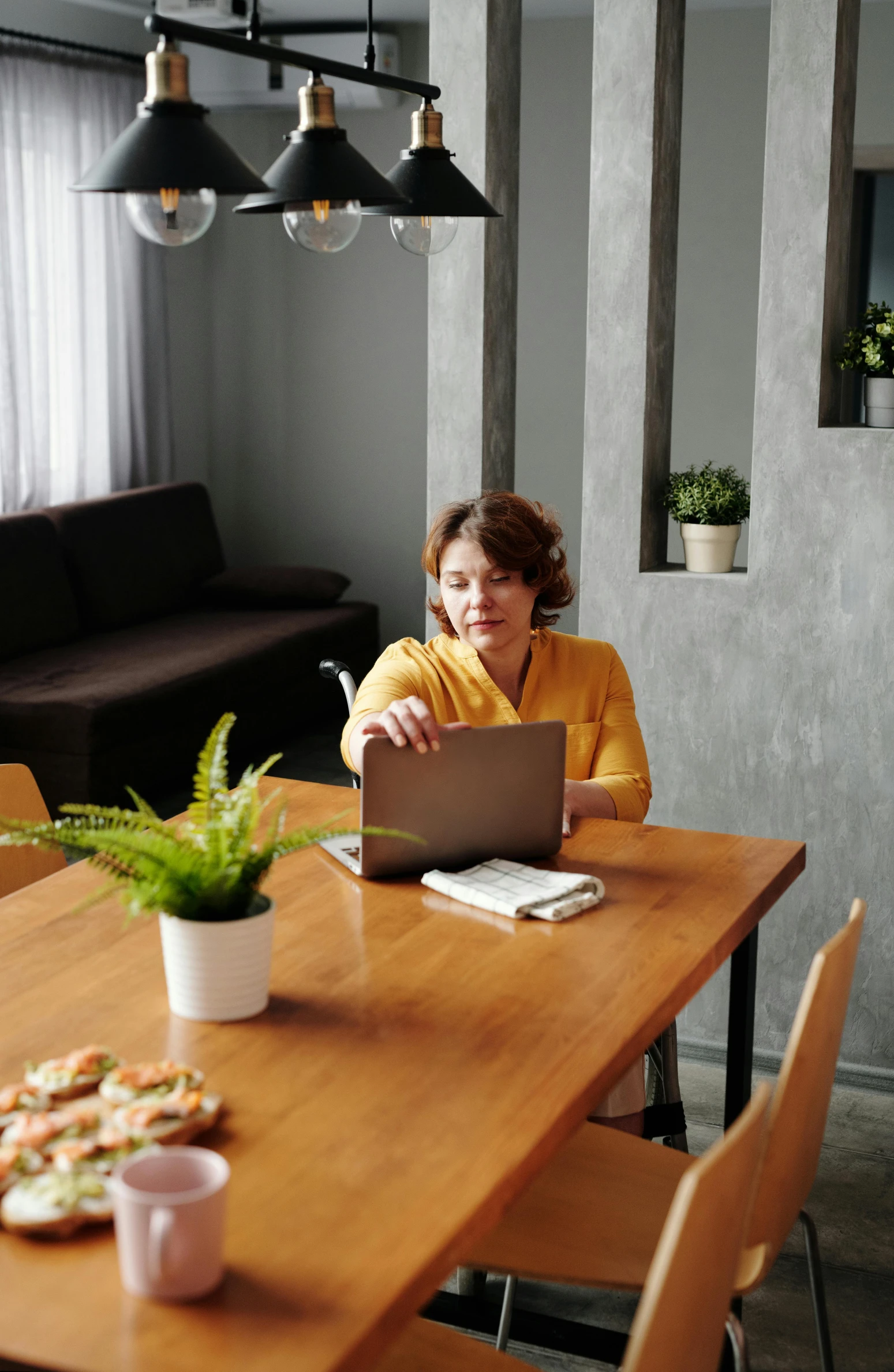 a woman sitting in a chair with a laptop on her lap