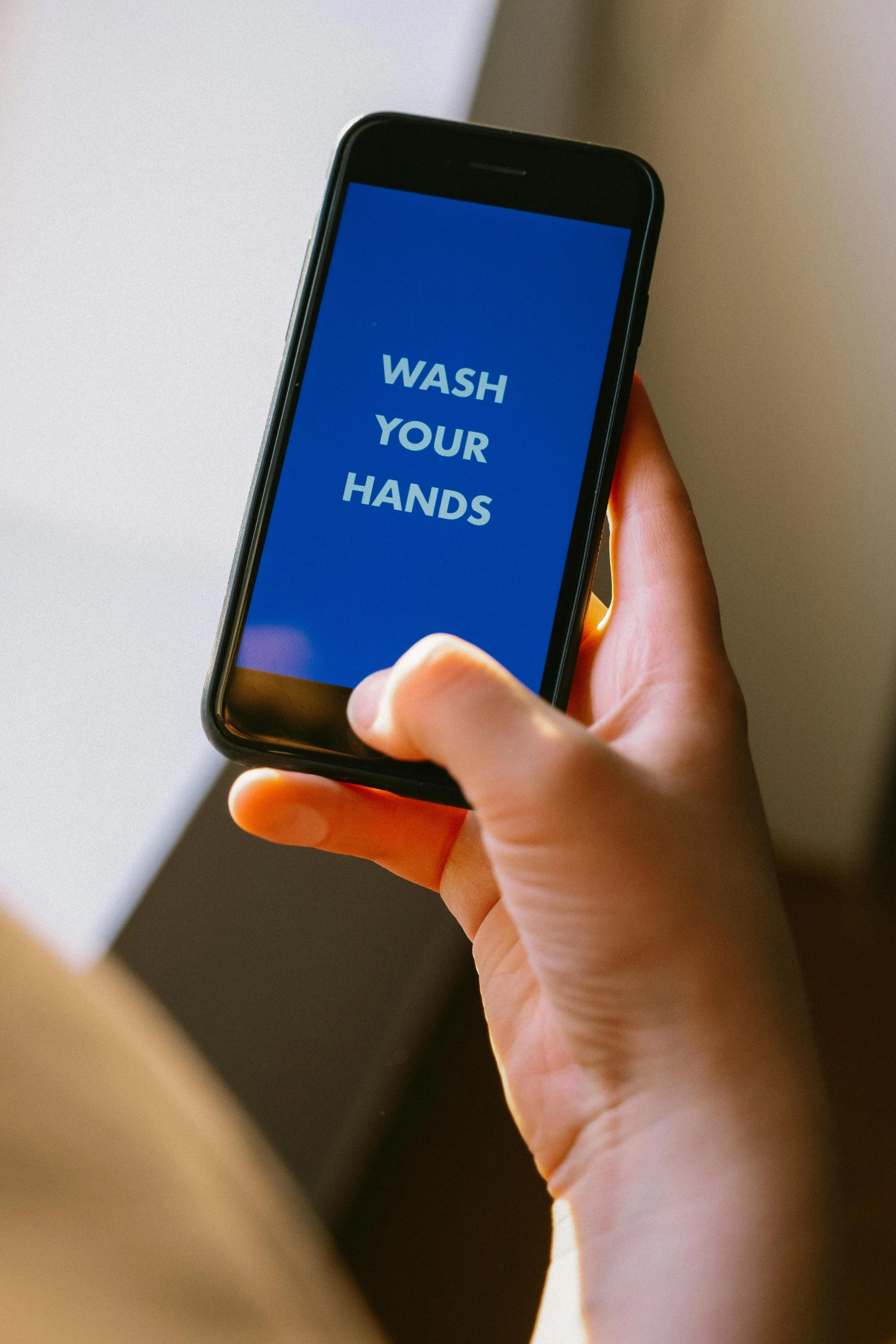 a close up of a person holding a cell phone, wash, hands straight down, thumbnail, displayed