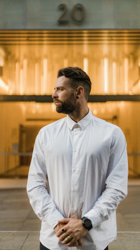 a man is standing in front of a light building