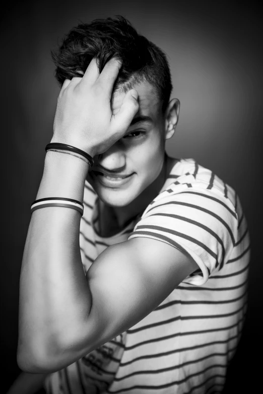 a black and white photo of a young man, a black and white photo, inspired by Ludovit Fulla, tumblr, happening, wearing stripe shirt, clothed!! lucien levy - dhurmer, naughty smile, artem