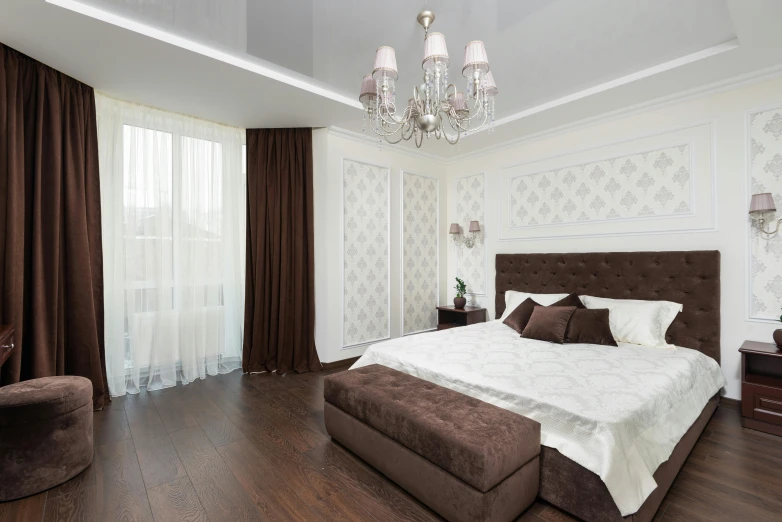 an elegant bedroom with white walls and wood floors