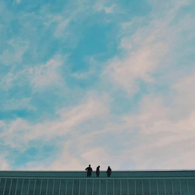 a couple of people standing on top of a building, an album cover, inspired by Elsa Bleda, unsplash, minimalism, sky blue, threes, light academia aesthetic, a group of people