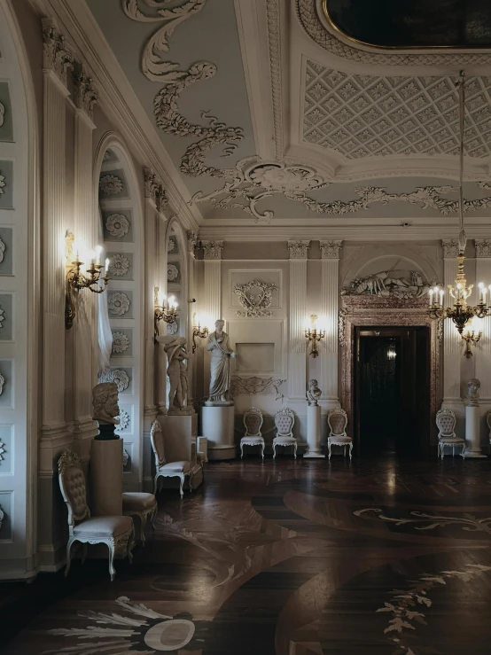 a very ornately decorated room with gold chairs