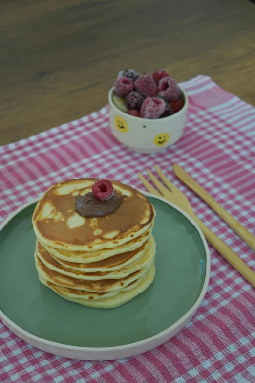 a stack of pancakes sitting on top of a green plate, inspired by Richmond Barthé, raspberry, youtube thumbnail, melbourne, chocolate sauce