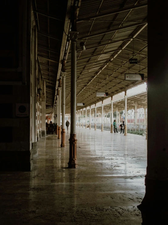 a train station filled with lots of people, unsplash contest winner, hyperrealism, empty warehouse background, colonnade, photo taken on fujifilm superia, rain lit