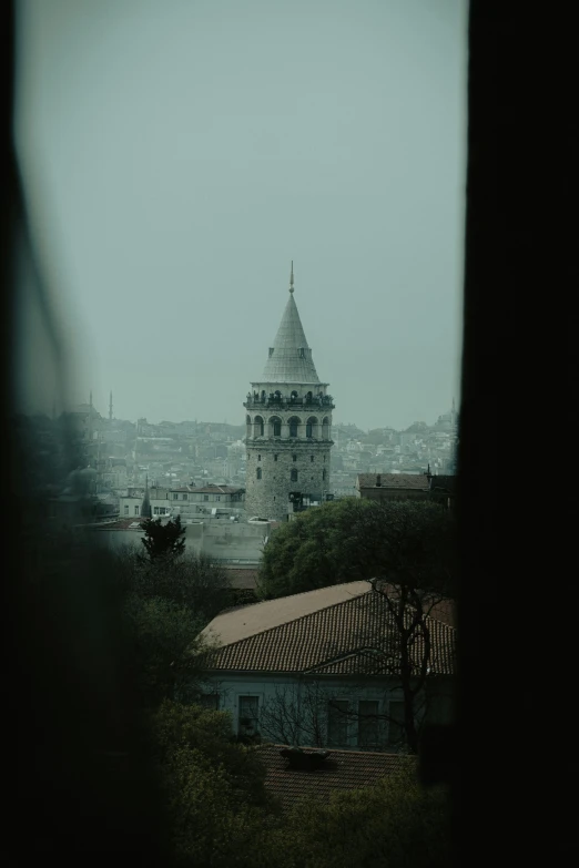 a view of a clock tower through a window, a matte painting, inspired by Elsa Bleda, pexels contest winner, hurufiyya, istanbul, gray sky, gif