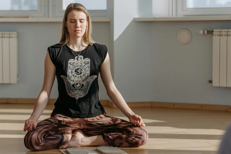 a woman sitting in the middle of a yoga pose, a portrait, by Nina Hamnett, unsplash, hurufiyya, low quality photo, sanskrit, alexey egorov, front facing