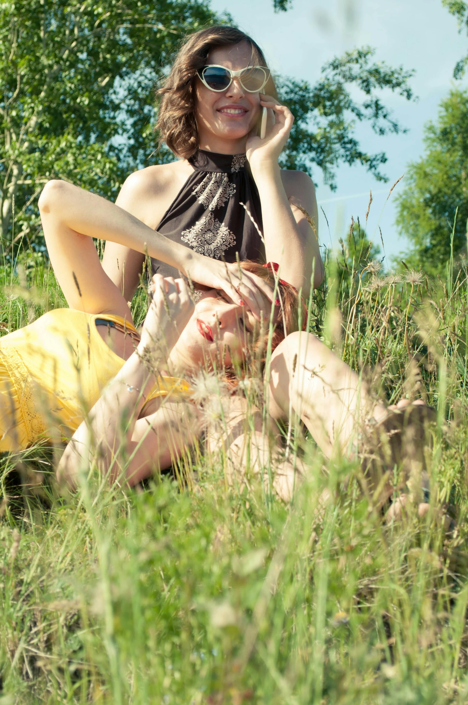 a woman is smiling and posing on the grass