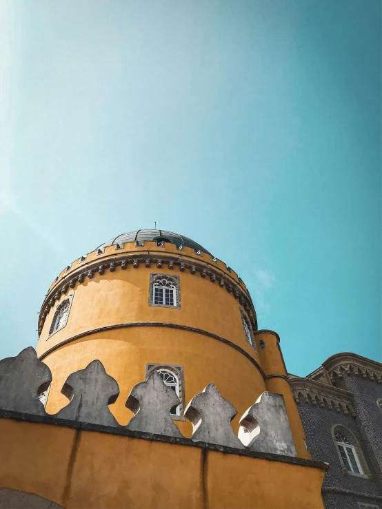 a yellow building with a blue sky in the background, an album cover, pexels contest winner, renaissance, dome of wonders, azulejo, thumbnail, castle wall