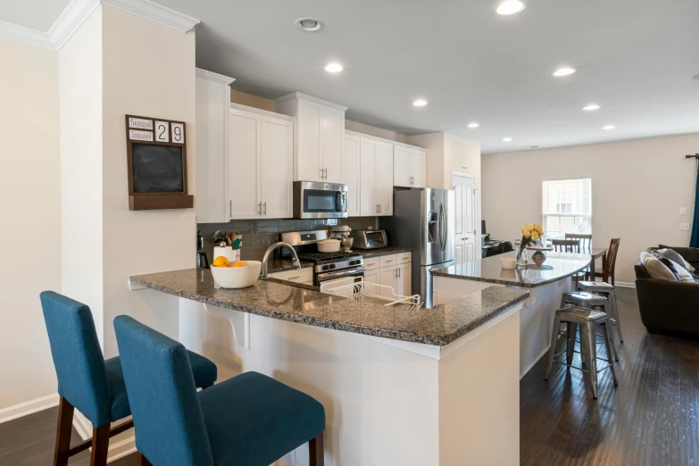 kitchen island with seating and bar stools in large room